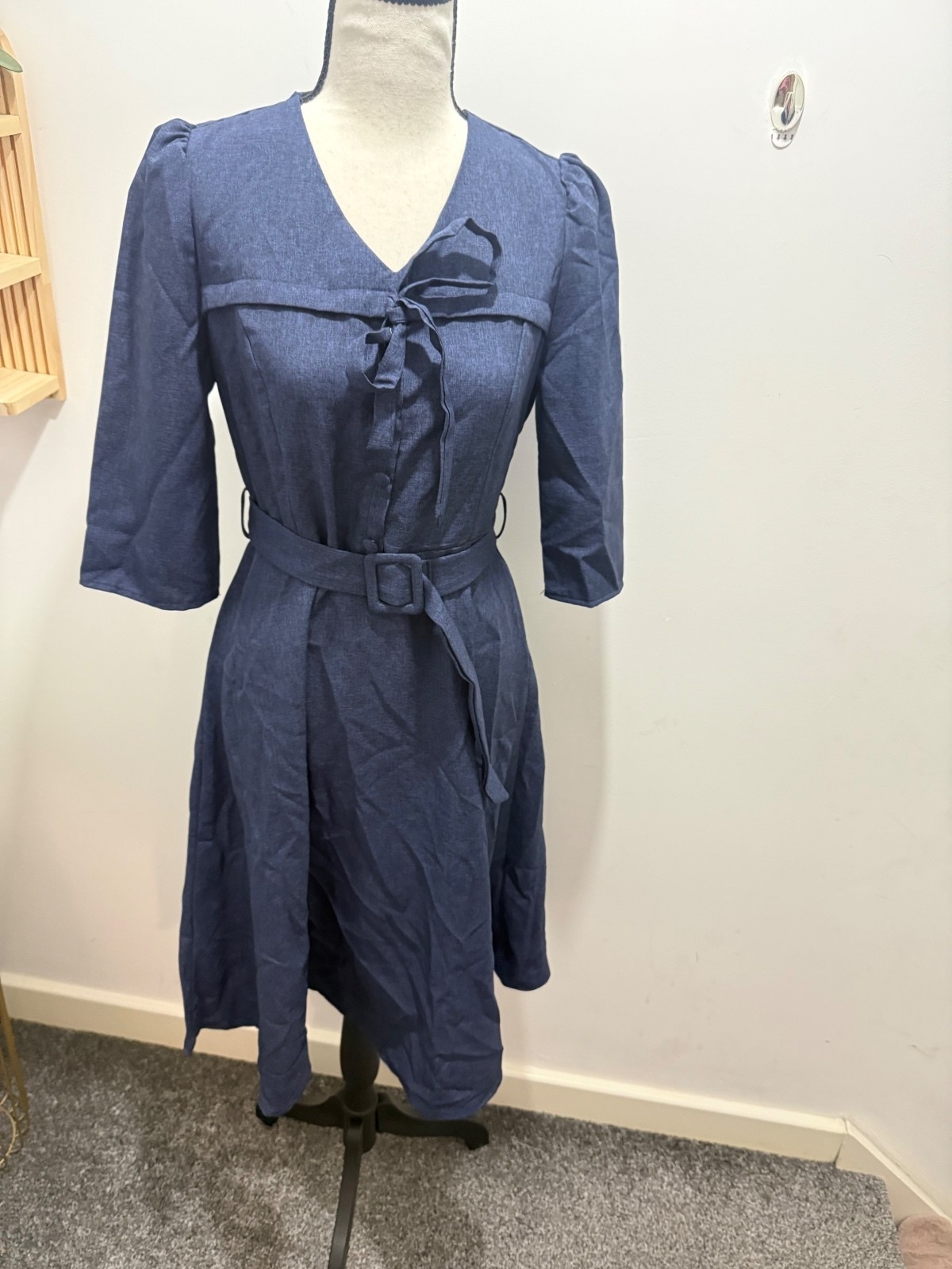 Elegant Blue Knee-Length Dress with Fabric Belt, Bow Tie Neckline, and Button-Up